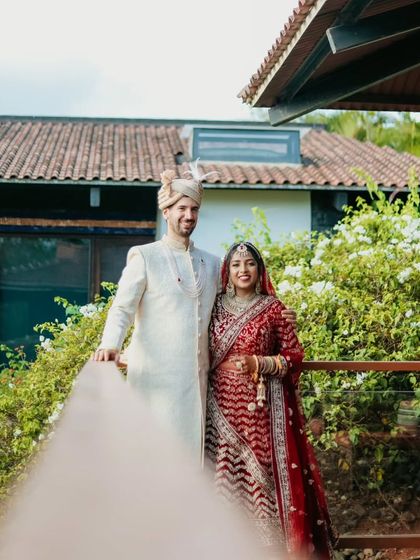 A classic couple portrait on a resort balcony, capturing their elegance and the beauty of the destination.