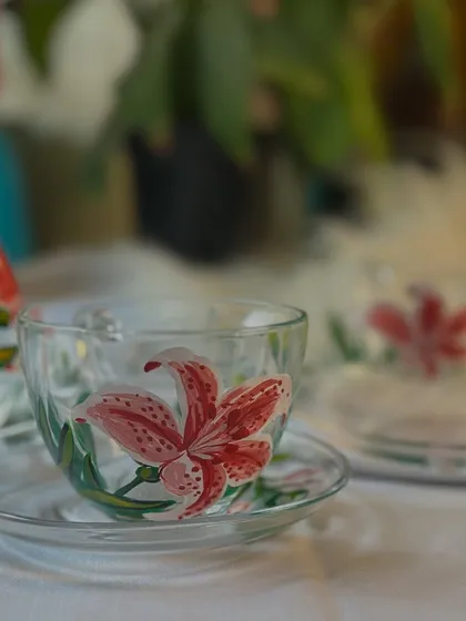 A beautiful shot of my hand-painted lily teacup and saucer set. The delicate pink and white flowers bring a touch of elegance to your tea time.