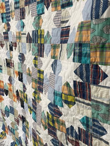 An angled view of the Sawtooth Star shirt quilt, showing the texture created by the quilting.