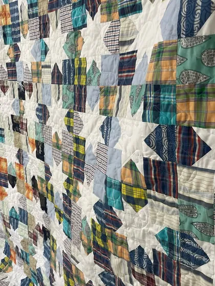 An angled view of the Sawtooth Star shirt quilt, showing the texture created by the quilting.