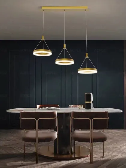 A set of three ring pendants over a dining table. This clean and modern setup provides great task lighting with a sophisticated look.