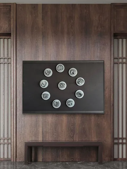 The 'Navagraha' artwork from the Cutting Edge series, arranged in a circle to harness cosmic energy. It brings a sense of harmony and celestial grace to this wood-paneled room.