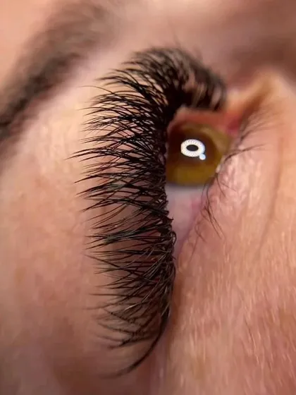 The details make the difference. This extreme close-up showcases the precision required for eyelash extensions, a highly sought-after skill that we cover in-depth in our cosmetology program.