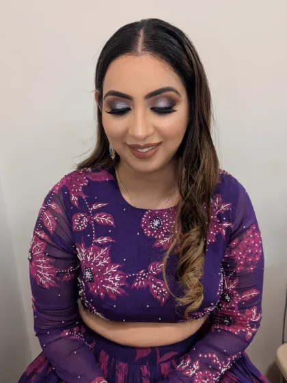 For those who love a touch of drama, this full glam look is perfect for a cocktail or sangeet night. A shimmering silver and black smokey eye is balanced with a flawless base and a neutral lip, creating a look that is both bold and sophisticated.