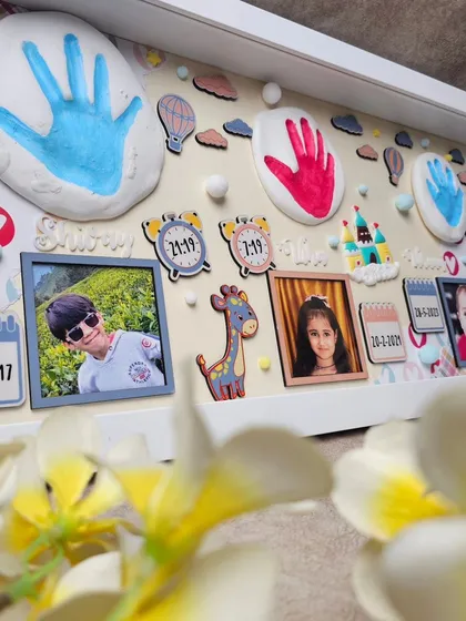 Preserve those precious early moments with a custom impression frame, capturing your children's handprints, photos, and birth details in a beautiful display.