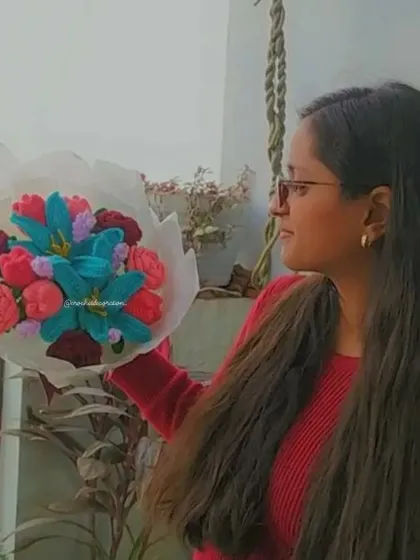 The daughter of our duo holding a vibrant, custom-made bouquet with blue lilies and multicolored roses. Each bouquet is a unique piece of art, crafted with love.
