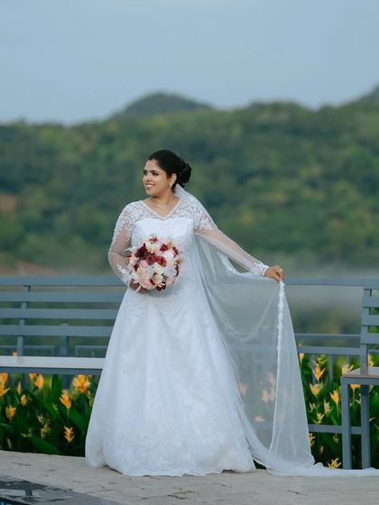 The bride stands by the poolside, her gown and veil catching the light. This is an example of a solo bridal portrait that feels both elegant and serene.