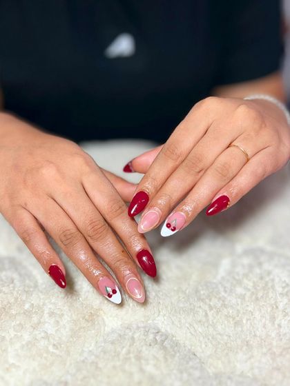 Another variation of the red French manicure, this time with cute cherry accents. This is a playful and chic design.