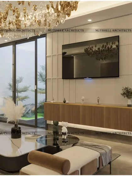 A view of the family lounge's media wall, featuring a floating console and a stunning chandelier that adds a touch of glamour. The large glass doors open to a garden, blurring the line between indoors and out.