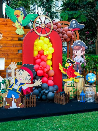 The pirate section of the stage, complete with a ship's wheel, parrots, and treasure barrels.