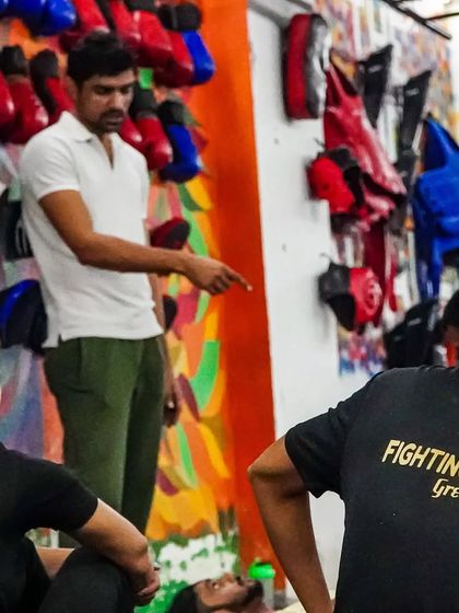 A coach providing instruction during a personal training session. We offer one-on-one coaching for those who want to take their MMA and boxing skills to the next level.