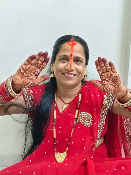 Maa showing her beautiful mehndi for Chhath Puja.