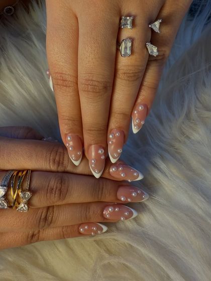 Another view of the classic French manicure with pearl accents. The stiletto shape adds a modern edge to this timelessly sophisticated and elegant design.
