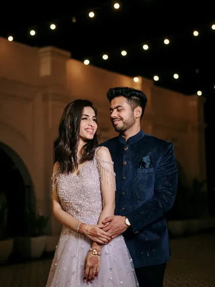 A happy and relaxed portrait of the couple enjoying their engagement night, with the beautiful architecture and lighting adding to the celebratory feel.