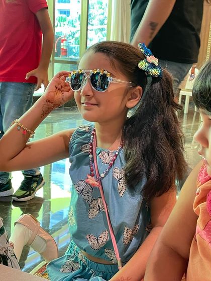 This young guest looks so chic in her custom-decorated sunglasses. It's an activity that combines crafting with fashion, and the kids absolutely love it.