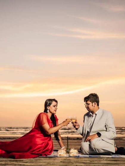 A toast to their future together during a beautifully styled picnic on the beach as the sun goes down. I can help arrange props to make your theme come to life.