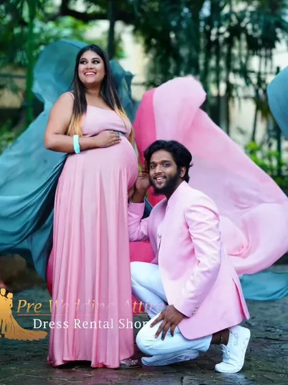 This couple's portrait highlights the soft drape of the dual-tone flying tail gown. The flowing pink and grey fabric provides a beautiful, artistic backdrop for a memorable maternity picture.