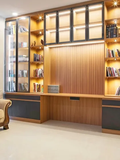 A home should have a space for quiet reflection. I designed this wall-to-wall library and study area to be a personal retreat. The warm wood, backlit glass cabinets, and integrated desk create a sanctuary for books and focus, proving that function and beauty can coexist perfectly.