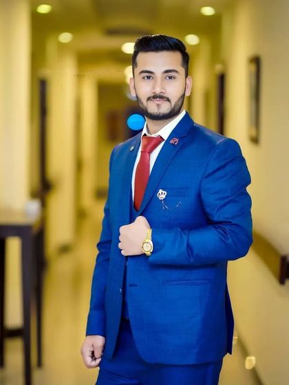 Every man deserves to look and feel attractive on a special day. This client is styled in a classic blue suit with a red tie, and my grooming work ensures his hair and skin are picture perfect.