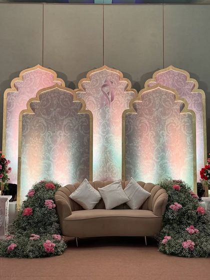 The same elegant stage under different lighting, showing how pastel-colored lights can change the mood and add a dreamy quality to the decor.