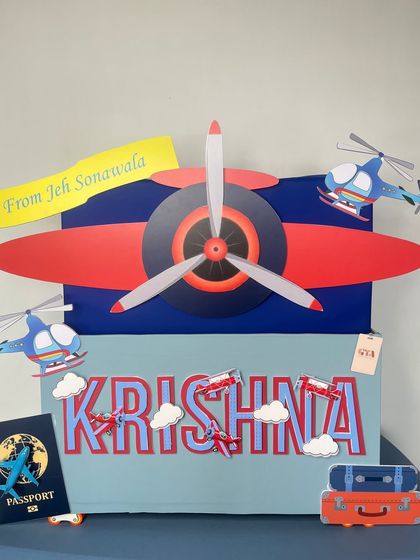 The complete airplane-themed gift setup, showing the custom 'passport', luggage, and various aircraft decorations that bring this exciting birthday story to life.