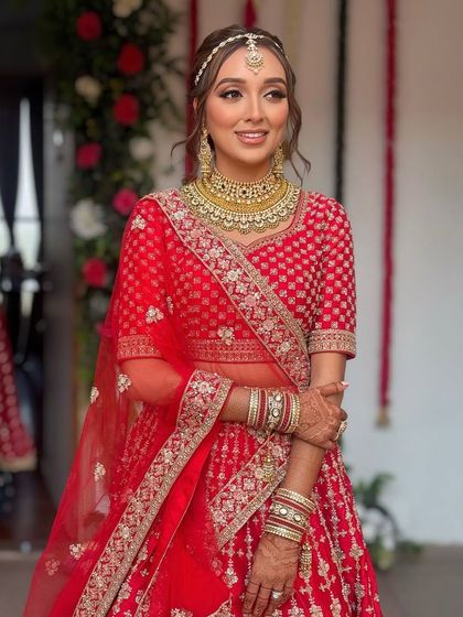 The bride looks radiant. The soft waves frame her face beautifully, and the hairstyle works perfectly with her dupatta.