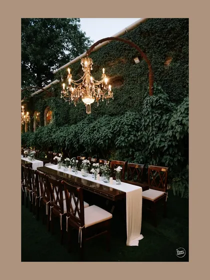 A detail shot of the elegant reception decor, featuring a long table setting under a beautiful chandelier.