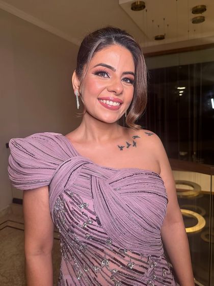 A chic and modern updo with soft, face-framing tendrils, perfect for a party or special event.