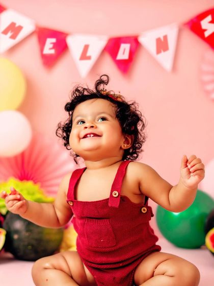 A look of pure happiness. This watermelon-themed session is perfect for a summer baby's first birthday celebration.