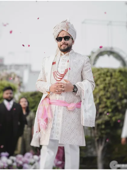 The groom's stylish entrance, captured as he walks in with confidence and joy, ready for the big moment.