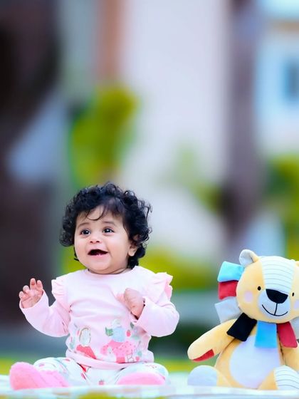 Another angle of the baby and teddy bear picnic, capturing a joyful, interactive moment.