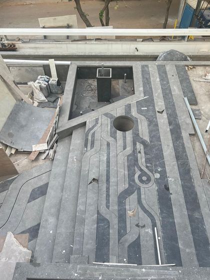 A custom floor pattern being installed, inspired by waves and boats to reflect a client's love for travel. This shows the process of creating personalized and meaningful design elements.