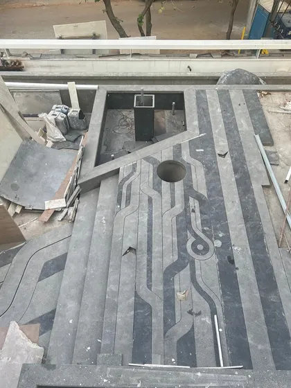 A custom floor pattern being installed, inspired by waves and boats to reflect a client's love for travel. This shows the process of creating personalized and meaningful design elements.