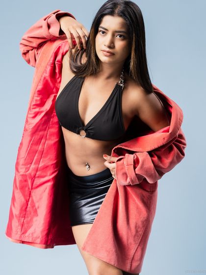 A playful pose with the red coat, showing a different side of the model's personality.