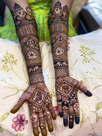 A royal-themed design with palace architecture, doli-bearers, and a Ganpati motif hidden within a diamond-shaped pattern.