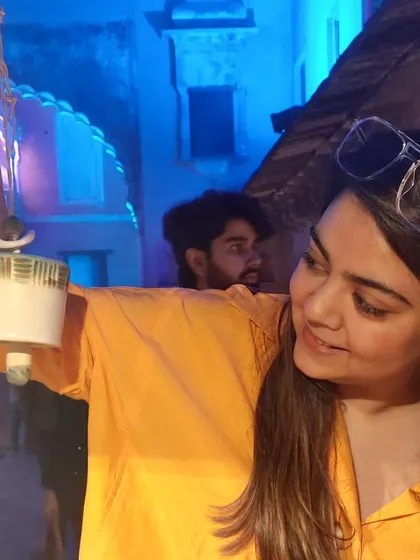 A young customer enjoying the sound of one of my ceramic bells at the Bhopal Potter's Market at night. The festive lights created a magical atmosphere.