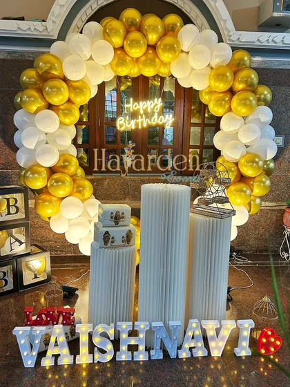 A beautiful gold and white balloon ring, perfect for a surprise birthday at home. The 'BABY' blocks and marquee letters add a personal touch.