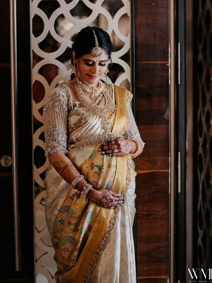 An intimate portrait of me cradling my baby bump, the intricate details of my embroidered blouse visible.