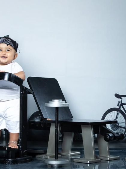 A happy baby enjoying his time in the mini gym, ready for his next set.
