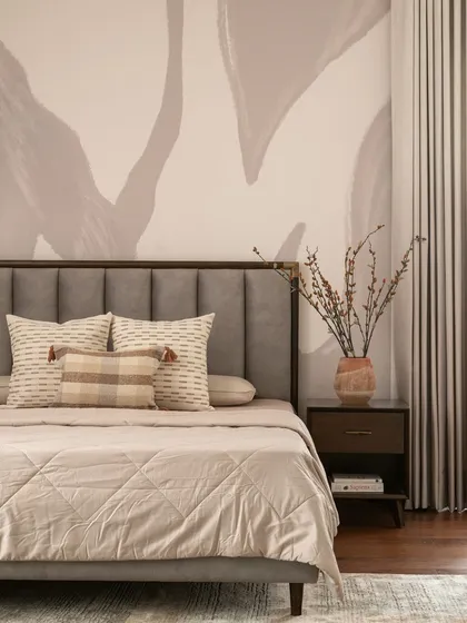 A close-up detail of the bedside styling, where the soft wallpaper pattern complements the natural textures of the dried flowers and bedding.