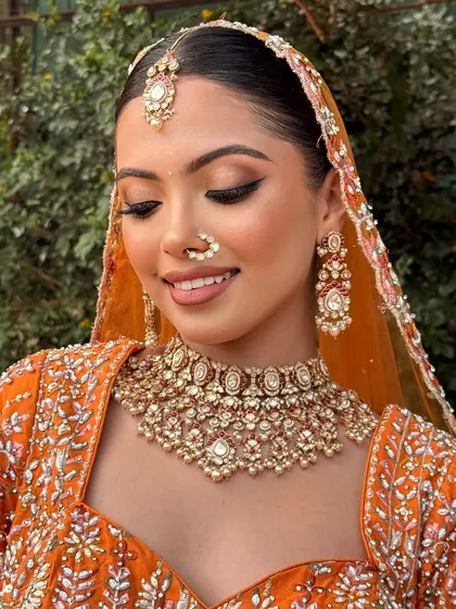 A close-up of the soft glam makeup, with beautifully blended eyeshadow and a perfect winged liner that enhances her eyes.
