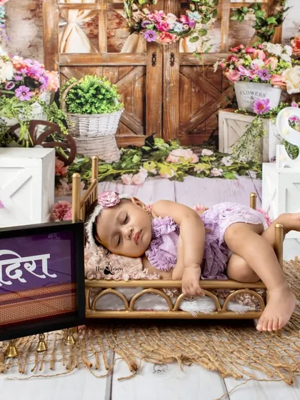 Capturing the peaceful moments of a half-birthday milestone. Our sitter sessions are perfect for documenting that adorable stage, with soft, dreamy setups like this floral garden theme in our Dronagiri studio.