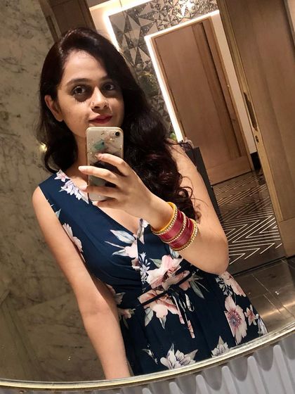 A floral V-neck jumpsuit is another fantastic one-piece option for vacation. This mirror selfie captures a simple yet pretty look that's perfect for a resort dinner or an evening out.