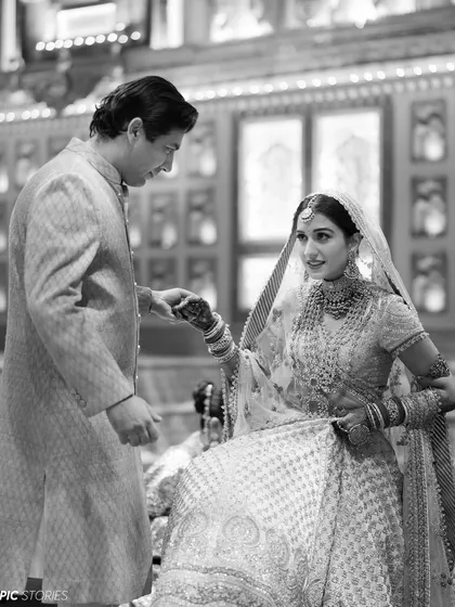 A classic black and white shot of a tender moment between the bride and groom. This timeless style strips away all distractions, focusing purely on the emotion and connection shared between them.
