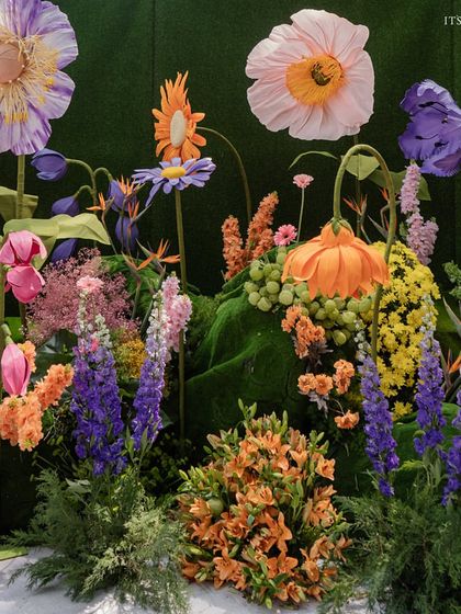 A close-up of the giant, handcrafted paper and silk flowers, showcasing the artistry and detail that went into creating this surreal garden.
