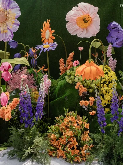A close-up of the giant, handcrafted paper and silk flowers, showcasing the artistry and detail that went into creating this surreal garden.