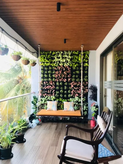 A complete balcony transformation in Bangalore. This finished project features a custom living wall with varied plant textures, creating a perfect backdrop for a relaxing swing seat and turning the space into a private urban oasis.