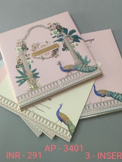 This pink invitation is adorned with majestic peacocks on a balustrade, set against a traditional arch. The design is both colorful and regal, and includes three inserts.