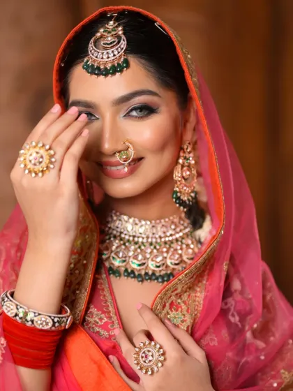 A fairytale moment captured. This close-up highlights the sharp, kohl-rimmed fox eyes and flawless dewy skin, framed by a beautiful dupatta for a look that is both traditional and enchanting.