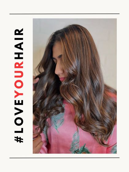 A side profile of the same brunette balayage, showing how the highlights frame the face and add dimension to the hair.